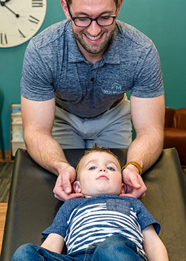 Chiropractor Fargo ND Fargo Seth Lunneborg with Child Chiropractor Fargo ND Fargo Seth Lunneborg with Child